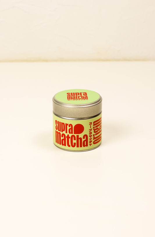 Packshot de la boîte métallique Origin Matcha Saemidori 30g SUPRAMATCHA sur fond crème