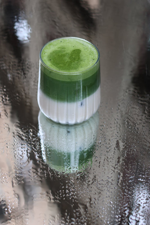 Matcha latte glacé Supramatcha devant une vitre embuée